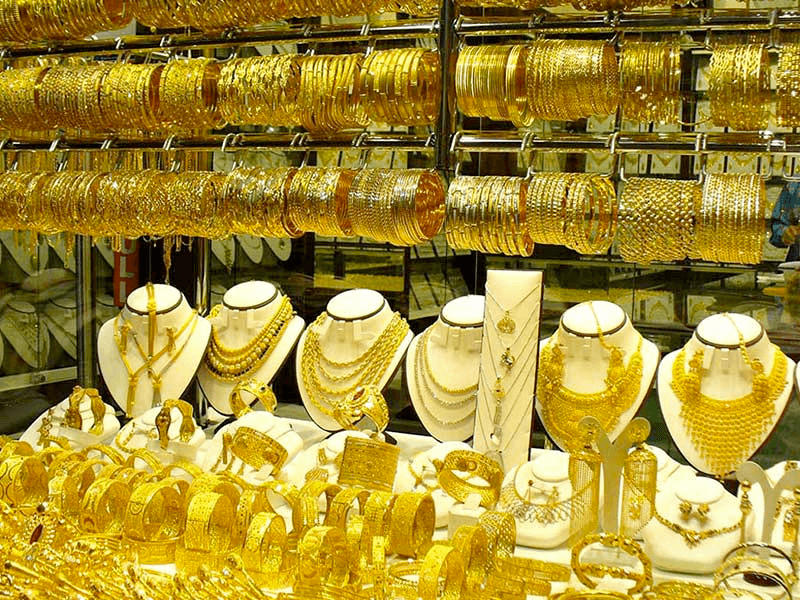 A display of gold jewelry Description automatically generated